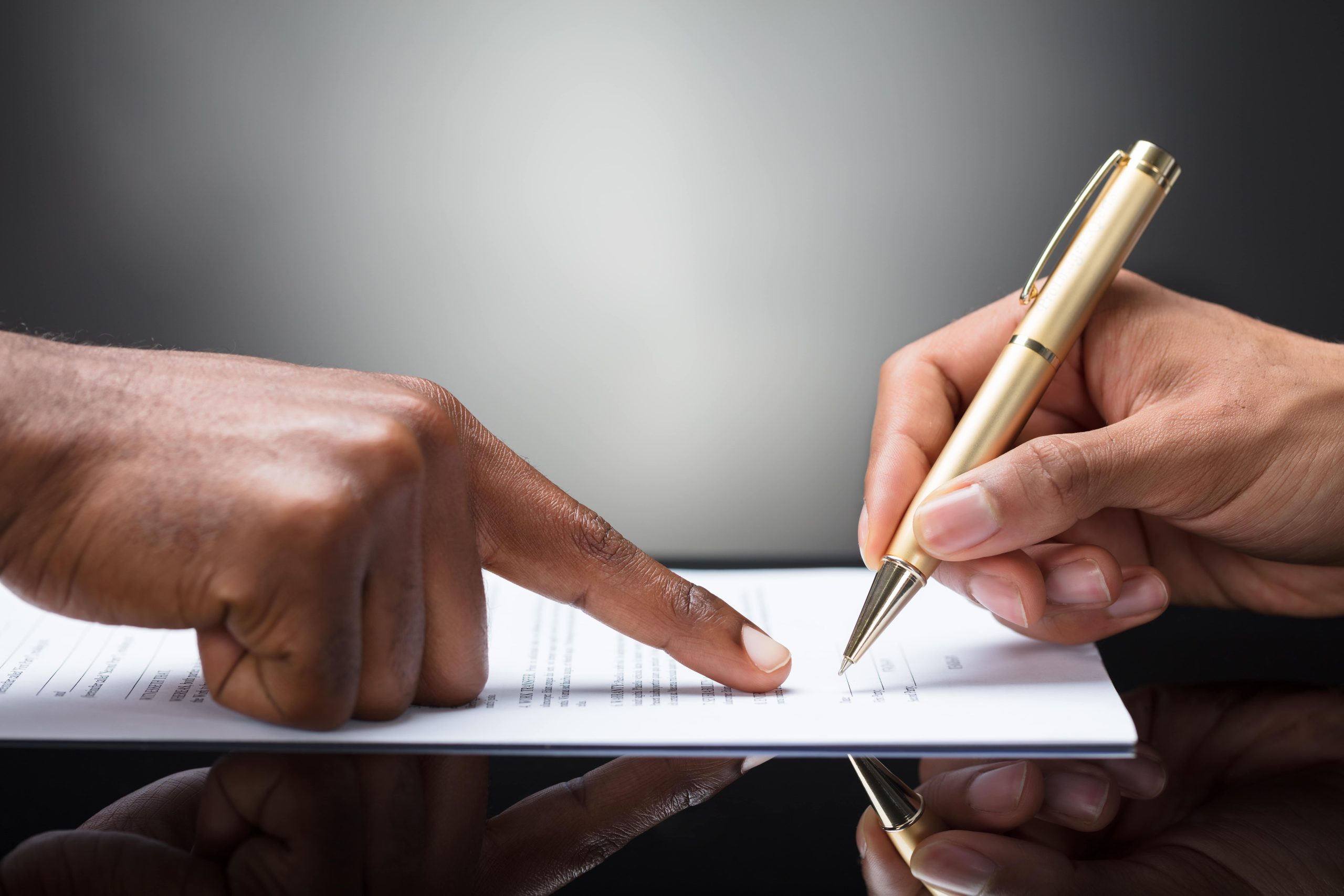 Lender helping with signing a document Lender helping with signing a document